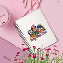 Notebook with 'The Artsy Girls' Club' design on a pink background with flowers and stationery items.