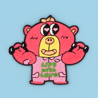 Embroidered pink cartoon bear patch/sticker with 'Lift with Love' text on a light blue background