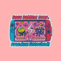 Boss Battle Frog vinyl sticker featuring two cartoon frogs battling on a handheld gaming console screen with the words “Boss Battle: Over” and “Freedom Unlocked” in bold, colorful text
