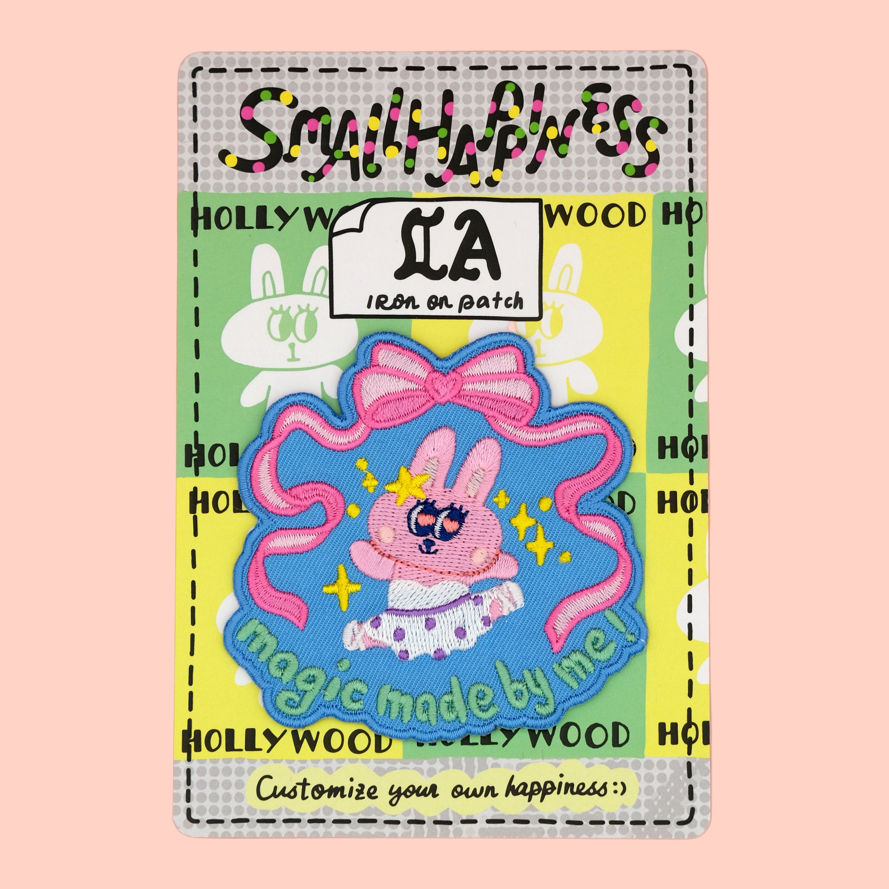Bunny ballet iron-on embroidery patch on custom designed backing card by SmallHappinessLA, displayed against a rose pink background

