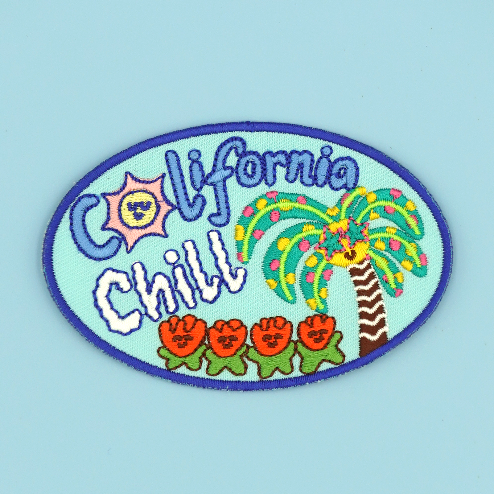 Colorful embroidered patch/sticker with 'California Chill' text and palm tree design on a light blue background