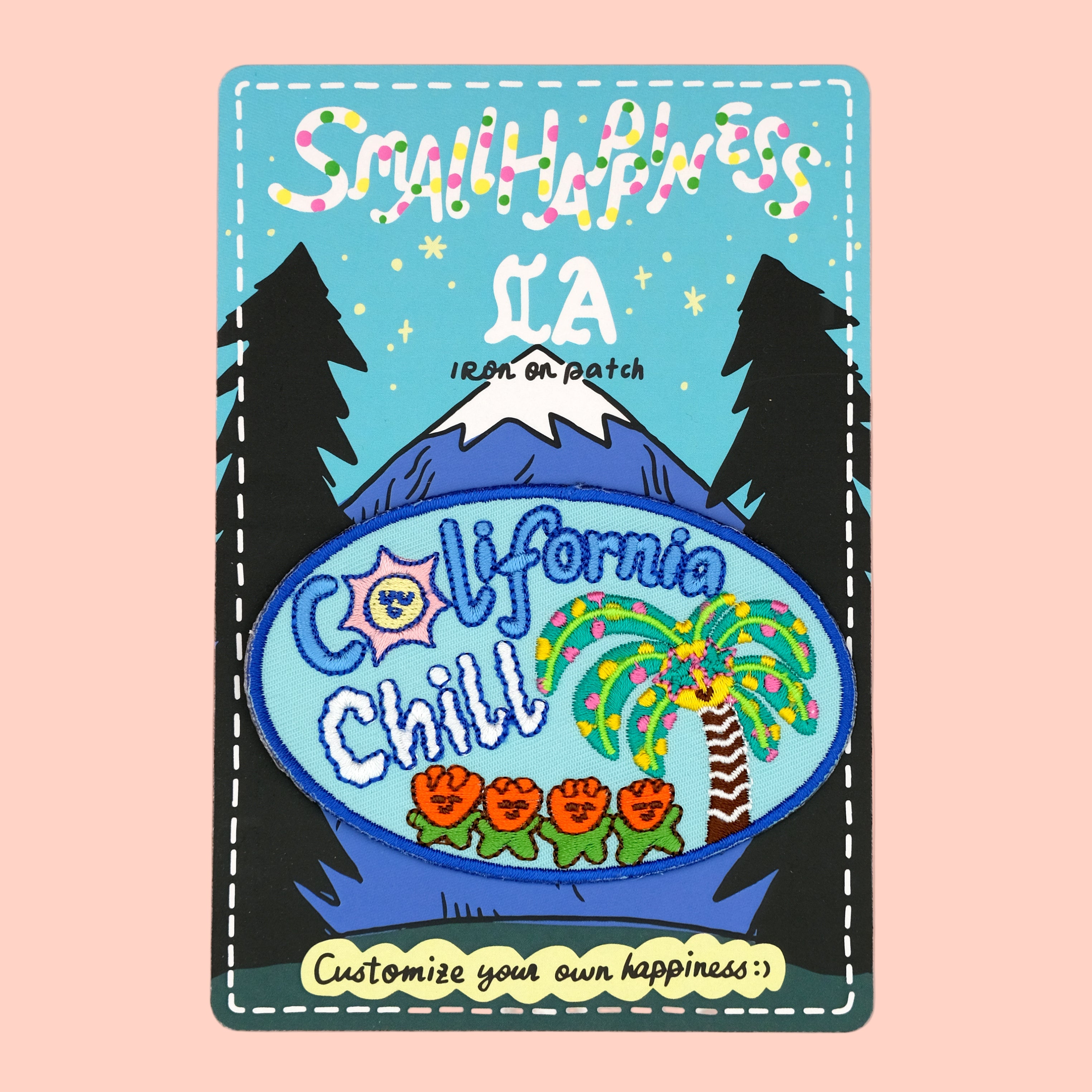 California chill - Palm tree iron-on embroidery patch on graffiti backing card, displayed against a rose pink background.