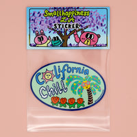 California Chill vinyl sticker featuring a cute palm tree and flowers, shown in SmallHappinessLA packaging with branded stock card and plastic bag