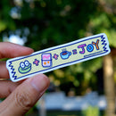 Colorful Mochi's Washi Tape Sticker held by a hand with a blurred natural background.
