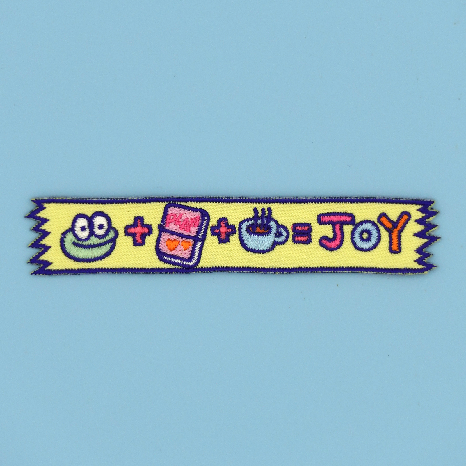 Mochi's washi tape embroidery patch/sticker displayed against a baby blue background by SmallHappinessLA