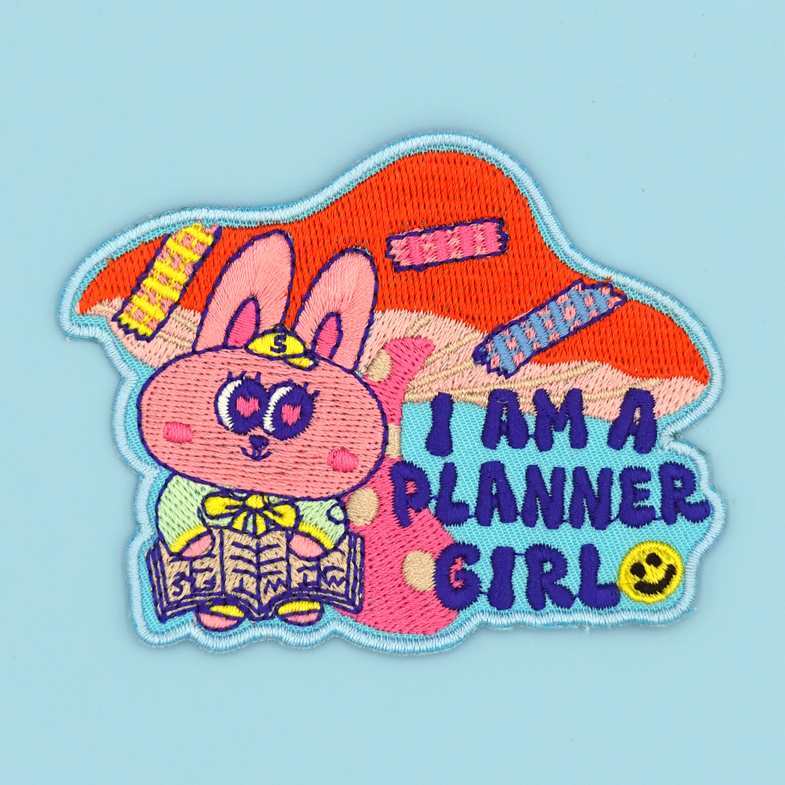 Planner Girl iron-on embroidery patch/sticker displayed against a baby blue background by SmallHappinessLA