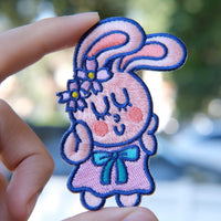 Self-love embroidered patch held in hand, showing size, texture, stitching details, and fabric under sunlight.
