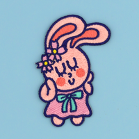 Embroidered patch/sticker of a cartoon bunny character with big ears on a blue background
