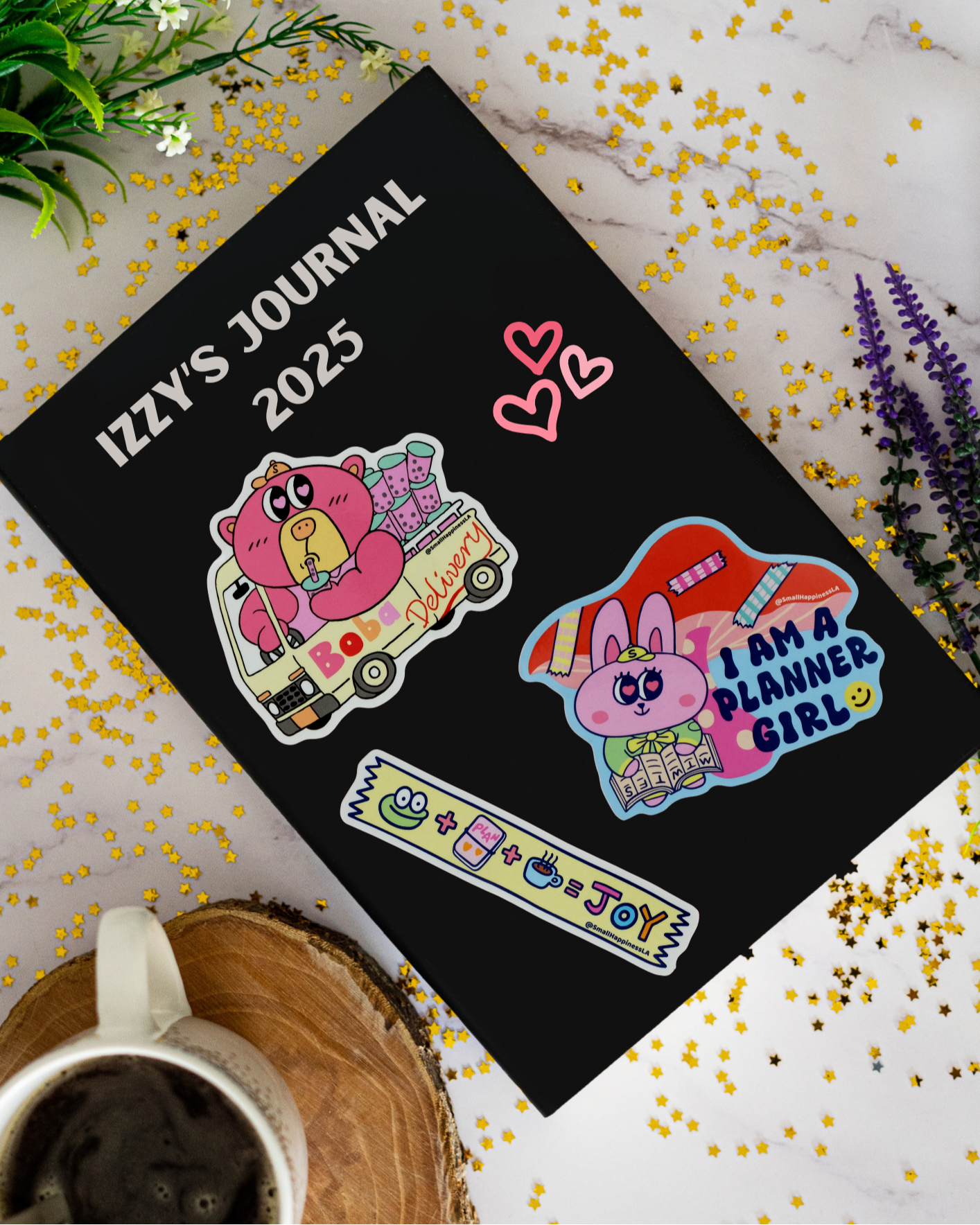 Journal with stickers on a journal book with flowers and a mug.