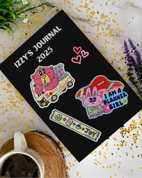Journal with stickers on a journal book with flowers and a mug.