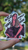 Vinyl sticker held by hand in natural day light featuring a fierce young woman with braids and jewelry holding a black wolf, with bold text that reads “Wild at Heart, Untamed by Nature,” designed in a dark, moody art style by SmallHappinessLA