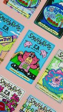 Video of multiple embroidered patches displayed on a soft rose pink background, showcasing design variety and texture.