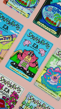 Video of multiple embroidered patches displayed on a soft rose pink background, showcasing design variety and texture.